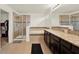 This bathroom features a tub, walk-in shower, and a granite countertop on a vanity with dark-stained cabinets at 5232 Villa Rosa Ave, St Cloud, FL 34771