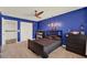 This bedroom features a dark wood bed frame, ceiling fan, and a window at 5232 Villa Rosa Ave, St Cloud, FL 34771