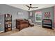 Bedroom featuring a crib, changing table, bookshelf, ceiling fan, and a bright window at 5232 Villa Rosa Ave, St Cloud, FL 34771