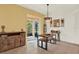 Cozy dining area with a modern table set, decorative wall art, and a view of the outdoor patio through sliding doors at 5232 Villa Rosa Ave, St Cloud, FL 34771