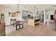 Modern kitchen featuring gray cabinets, a center island with bar stools, and a cozy dining area with custom lighting at 5232 Villa Rosa Ave, St Cloud, FL 34771