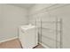 Bright laundry room with white washer and dryer, wire shelving, and tile floor at 5232 Villa Rosa Ave, St Cloud, FL 34771