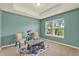 Bright living room featuring stylish decor, soft carpet, and a large window offering a pleasant outdoor view at 5232 Villa Rosa Ave, St Cloud, FL 34771