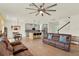 Open concept living space with a modern kitchen, cozy seating area, and elegant tile flooring throughout at 5232 Villa Rosa Ave, St Cloud, FL 34771