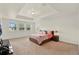 Spacious main bedroom featuring a tray ceiling, neutral carpet, and multiple windows providing abundant natural light at 5232 Villa Rosa Ave, St Cloud, FL 34771