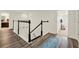 Elegant staircase with white railings, dark wood accents, and hardwood floors leading to the upper level of the home at 5232 Villa Rosa Ave, St Cloud, FL 34771
