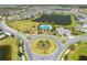 Aerial view of the community showcasing the playground, pool, ponds, and surrounding homes at 5408 Manchester Dr, St Cloud, FL 34771