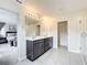 Double vanity bathroom with large mirror and walk-in shower at 8060 Cherrystone St, Leesburg, FL 34748