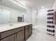 Well-lit bathroom with modern vanity, ample counter space, and shower-tub combo at 8060 Cherrystone St, Leesburg, FL 34748