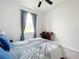 Comfortable bedroom featuring soft bedding, neutral colors, and natural light at 8060 Cherrystone St, Leesburg, FL 34748