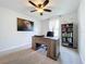 Bright home office featuring a desk, bookcase, and large window at 8060 Cherrystone St, Leesburg, FL 34748