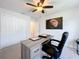 Home office with large desk, chair, and built-in closet at 8060 Cherrystone St, Leesburg, FL 34748