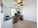 Spacious home office with a large desk and built-in shelving at 8060 Cherrystone St, Leesburg, FL 34748