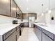 Contemporary kitchen showcasing stainless steel appliances, sleek dark cabinetry, and a large quartz island at 8060 Cherrystone St, Leesburg, FL 34748