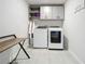 Laundry room with washer, dryer, cabinets, and bench at 8060 Cherrystone St, Leesburg, FL 34748