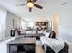 Comfortable living room with a large sectional sofa, a ceiling fan, and an open view to the modern kitchen at 8060 Cherrystone St, Leesburg, FL 34748