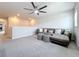 Inviting living area with sectional sofa, soft carpet, and ample natural light at 8060 Cherrystone St, Leesburg, FL 34748