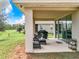 Relaxing outdoor patio with view of well-maintained yard and blue sky at 8060 Cherrystone St, Leesburg, FL 34748