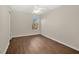 Bright bedroom with dark hardwood floors and ceiling fan at 1100 Bluegrass Dr, Groveland, FL 34736