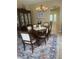 Formal dining room with chandelier, area rug, and hutch, ready for entertaining at 2719 Lakemoor Dr, Orlando, FL 32828