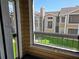 Community view from balcony, showing well-maintained lawns and neighboring buildings at 4401 Thornbriar Ln # 202, Orlando, FL 32822