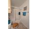 Clean bathroom features a classic white tile tub and shower combo, along with convenient towel storage at 4401 Thornbriar Ln # 202, Orlando, FL 32822