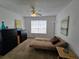 Serene bedroom with fan, dresser, and futon, creating a cozy and inviting atmosphere at 4401 Thornbriar Ln # 202, Orlando, FL 32822
