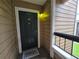 Cozy condo front door featuring a welcome mat and a charming unit number plaque at 4401 Thornbriar Ln # 202, Orlando, FL 32822