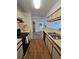 Bright kitchen with updated appliances, sleek countertops, and ample cabinet space overlooking dining area at 4401 Thornbriar Ln # 202, Orlando, FL 32822