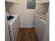 Convenient laundry room with washer and dryer, plus stylish wood-look flooring at 4401 Thornbriar Ln # 202, Orlando, FL 32822