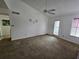Spacious living room with ceiling fan, neutral carpet, and ample natural light at 4401 Thornbriar Ln # 202, Orlando, FL 32822