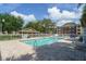 Community pool surrounded by lush trees and ample lounge space at 4401 Thornbriar Ln # 202, Orlando, FL 32822