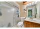 Bathroom features a shower and single sink with a view to the main bedroom at 668 Coral Way, Winter Springs, FL 32708