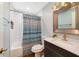 Well-lit bathroom with modern vanity, subway tile backsplash, and shower-tub combo with stylish curtain at 668 Coral Way, Winter Springs, FL 32708