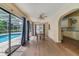 Bright dining area with wood floors and sliding glass doors to screened in pool at 668 Coral Way, Winter Springs, FL 32708