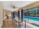 Bright dining area with wood floors and sliding glass doors to screened in pool at 668 Coral Way, Winter Springs, FL 32708