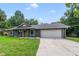 Charming single story home featuring a covered front porch and a two-car garage at 668 Coral Way, Winter Springs, FL 32708