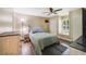 Comfortable bedroom with ceiling fan, hardwood floors, and window seating at 668 Coral Way, Winter Springs, FL 32708
