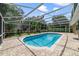 Sparkling pool surrounded by brick pavers and a screened enclosure at 668 Coral Way, Winter Springs, FL 32708
