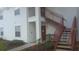 White two-story apartment building with red stairways leading to the second floor entryways at 11544 Westwood Blvd # 1325, Orlando, FL 32821