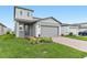 Attractive two-story home with manicured lawn and garden beds, a two-car garage and a covered entry at 1386 Current Pl, Haines City, FL 33844