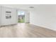 Bright living room with modern vinyl flooring, large windows, and sliding door access to the back yard at 1386 Current Pl, Haines City, FL 33844