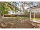 Sunny backyard with wooden fence and mature trees at 912 W 5Th St, Lakeland, FL 33805