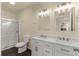 Bathroom with double vanity, large mirror, and a spacious shower at 912 W 5Th St, Lakeland, FL 33805