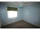 Bedroom features light blue walls, a window with curtains and a ceiling fan at 5027 Se 109Th Pl, Belleview, FL 34420