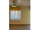 This bedroom features a ceiling fan and natural light from the window at 5027 Se 109Th Pl, Belleview, FL 34420