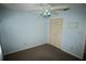 This bedroom features a ceiling fan and a closet with bifold doors at 5027 Se 109Th Pl, Belleview, FL 34420