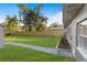 Grassy backyard featuring a well-maintained lawn with a sidewalk to an accessory building at 1321 Cloverlawn Ave, Orlando, FL 32806