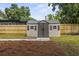 Well-maintained storage shed in a landscaped backyard with a wooden fence at 1321 Cloverlawn Ave, Orlando, FL 32806