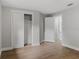 A bedroom with gray walls, a closet, wood-look floors and a view into the bathroom at 1321 Cloverlawn Ave, Orlando, FL 32806